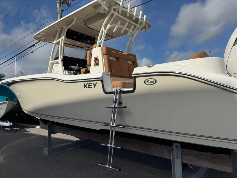 Slide: The Image of 2025 Key West 291 FS boat with ladder, displayed outdoors under a blue sky. - 12