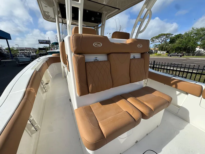 Slide: The Image of 2025 Key West 291 FS boat with tan seating and sleek design. - 13