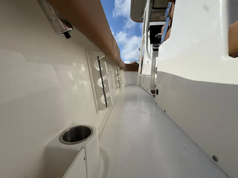 Slide: The Image of 2025 Key West 291 FS boat interior with cup holder and rod storage. - 17