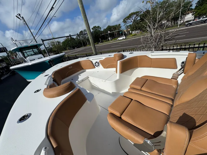 Slide: The Image of 2025 Key West 291 FS boat with tan seating and spacious deck. - 23