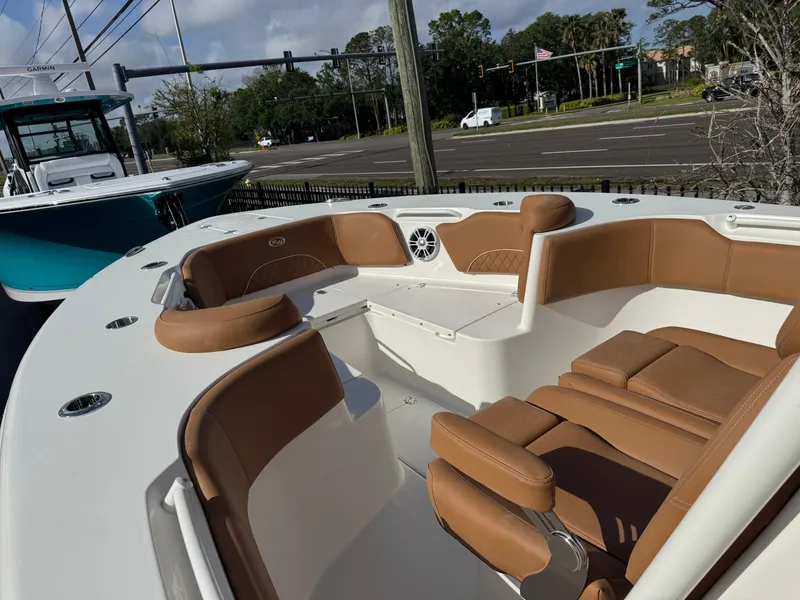 Slide: The Image of 2025 Key West 291 FS boat with tan seating, docked near a road. - 24
