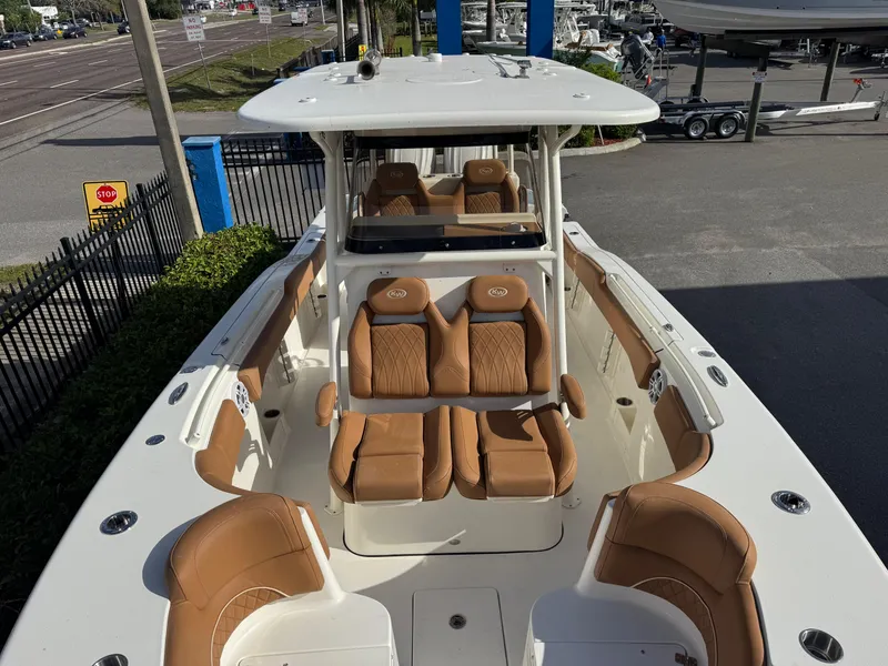 Slide: The Image of 2025 Key West 291 FS boat with tan seating and spacious deck layout. - 27