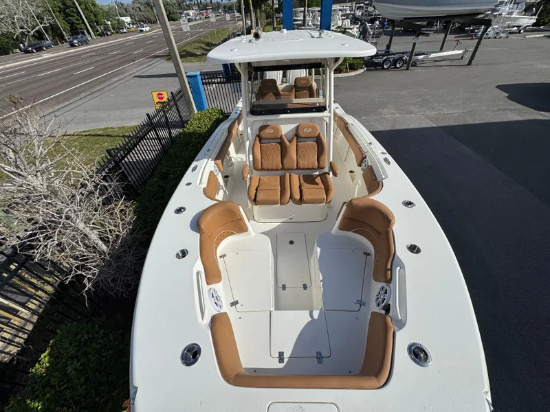 Slide: The Image of 2025 Key West 291 FS boat with tan seating, spacious deck, and modern design. - 28