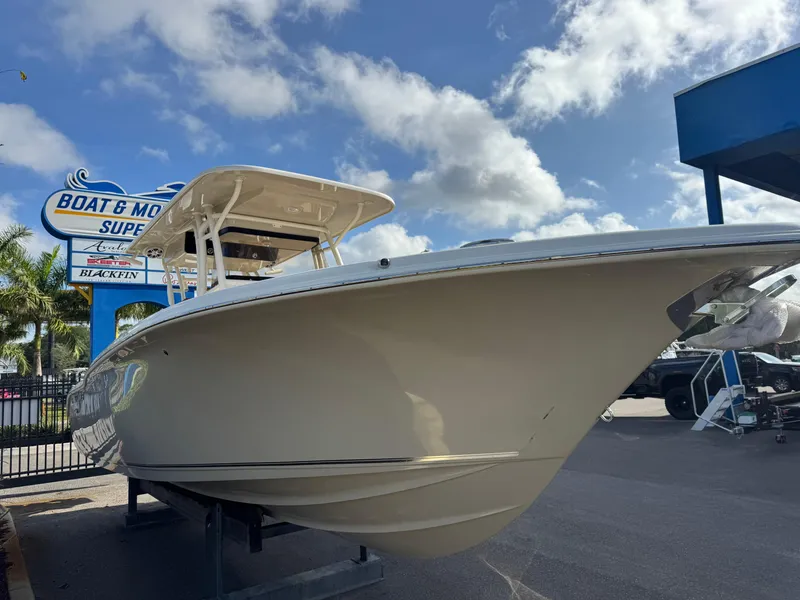 Slide: The Image of 2025 Key West 291 FS boat displayed at dealership under blue sky. - 3