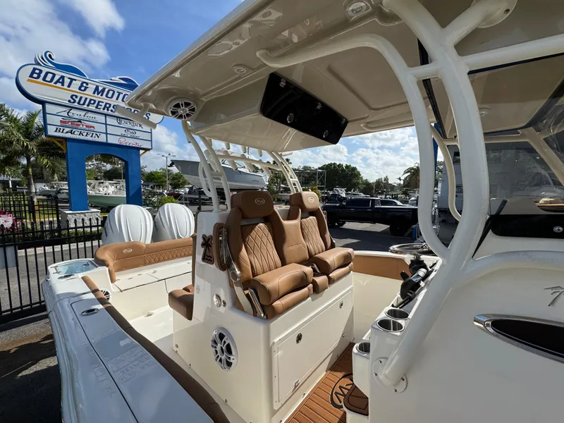 Slide: The Image of 2025 Key West 291 FS boat interior with luxurious seating at a dealership. - 32
