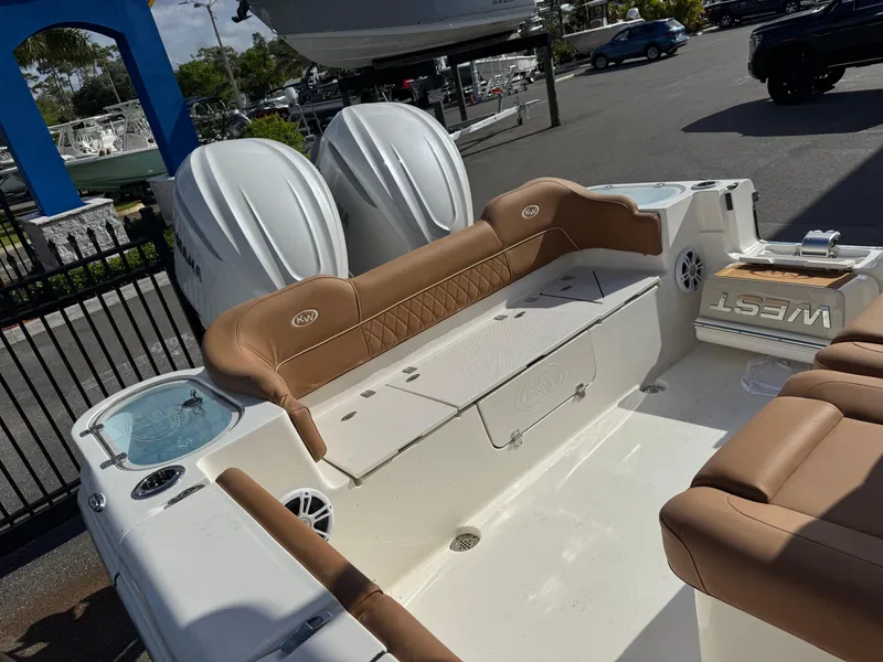 Slide: The Image of 2025 Key West 291 FS boat interior with tan seating and dual engines. - 35