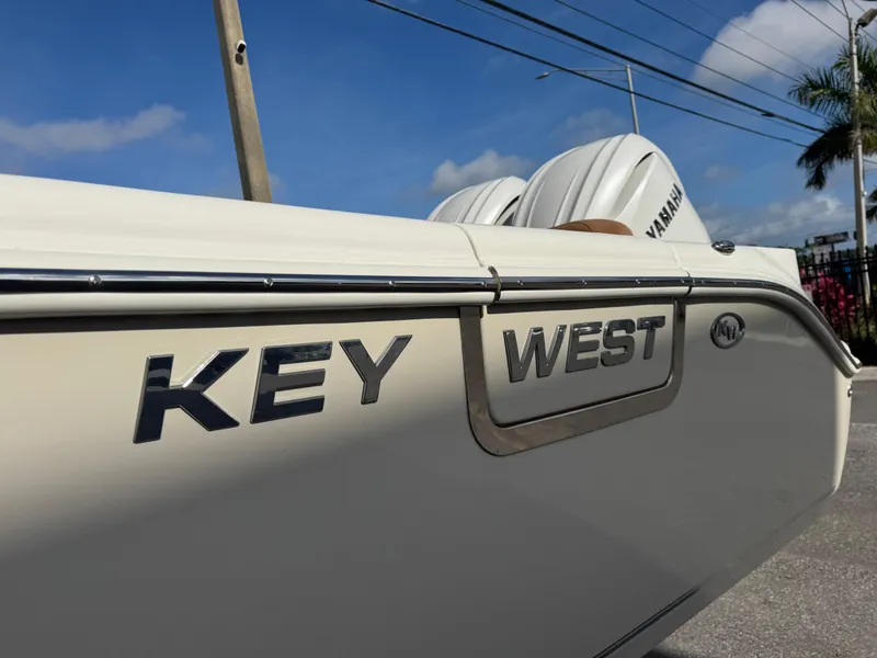 Slide: The Image of 2025 Key West 291 FS boat side view with Yamaha engines, clear sky background. - 4