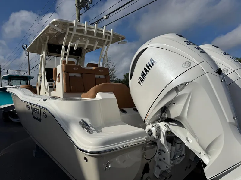 Slide: The Image of 2025 Key West 291 FS boat with Yamaha engine, docked under a clear sky. - 6