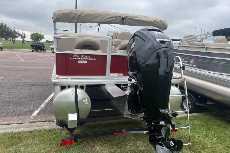 Slide: The Image of 2025 Sun Tracker Bass Buggy 18 DLX pontoon boat with Mercury outboard motor. - 2