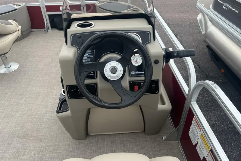 Slide: The Image of 2025 Sun Tracker Bass Buggy 18 DLX steering console with gauges and controls. - 4