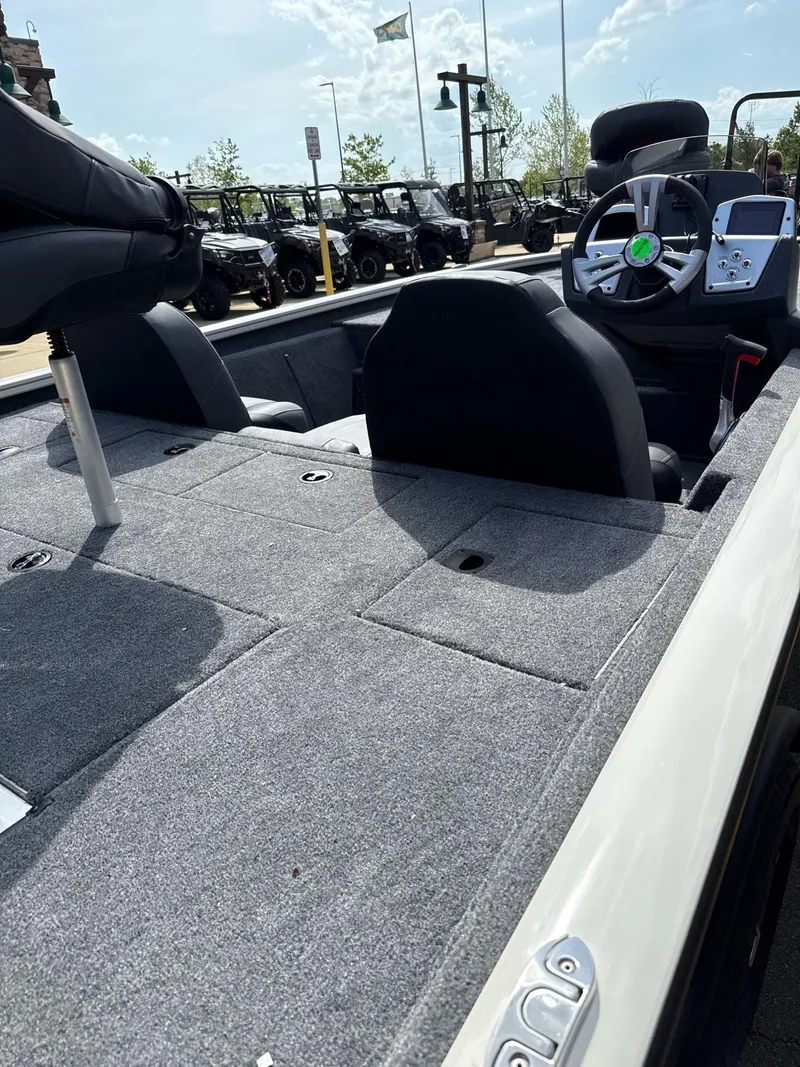 Slide: The Image of 2025 Tracker Pro Team 195 Tournament Edition boat interior with steering wheel and seating. - 2