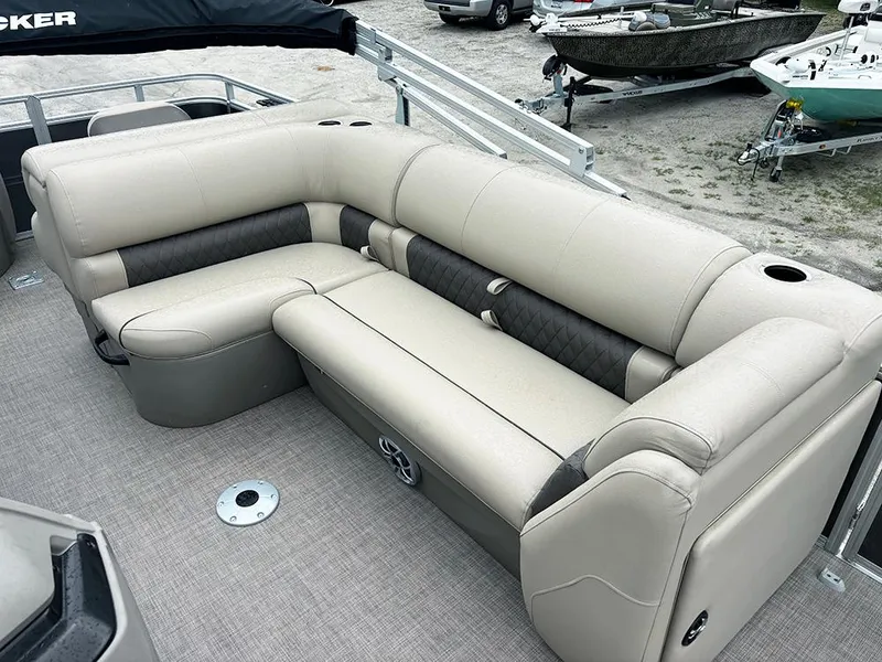 Slide: The Image of 2025 Sun Tracker Fishin' Barge 20 DLX pontoon boat with beige seating and carpeted deck. - 17