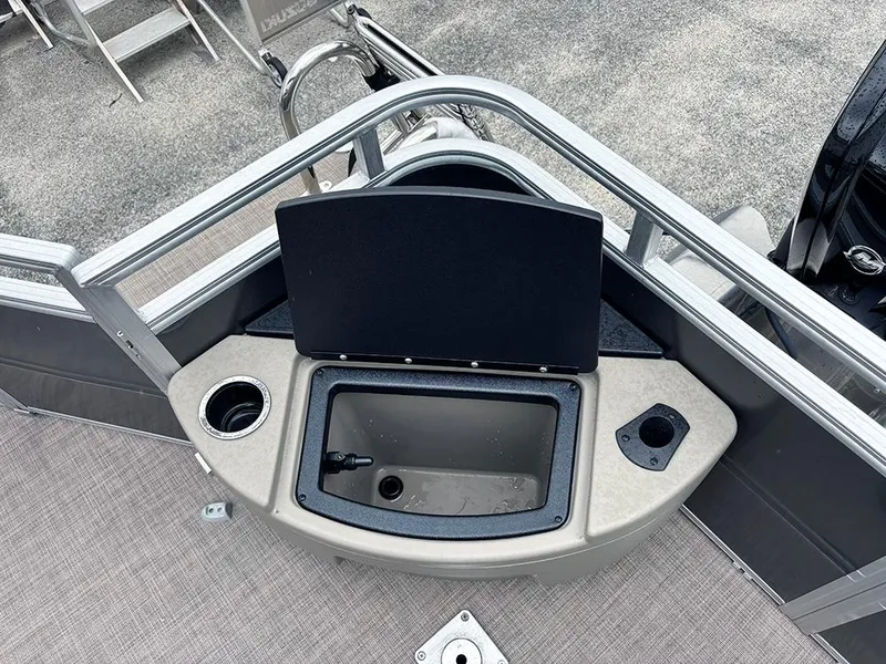 Slide: The Image of 2025 Sun Tracker Fishin' Barge 20 DLX boat deck with storage compartment and cup holder. - 21