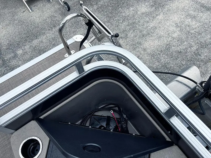 Slide: The Image of 2025 Sun Tracker Fishin' Barge 20 DLX deck with storage compartment and railing. - 22