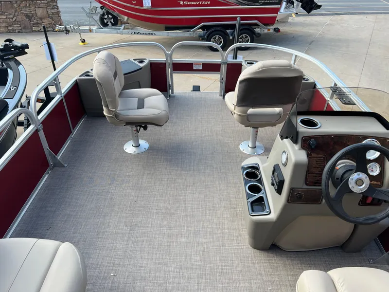Slide: The Image of 2025 Sun Tracker Bass Buggy 16 XL Select pontoon boat interior with seating and steering console. - 6