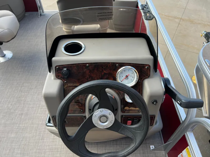 Slide: The Image of 2025 Sun Tracker Bass Buggy 16 XL Select dashboard with steering wheel and gauge. - 7