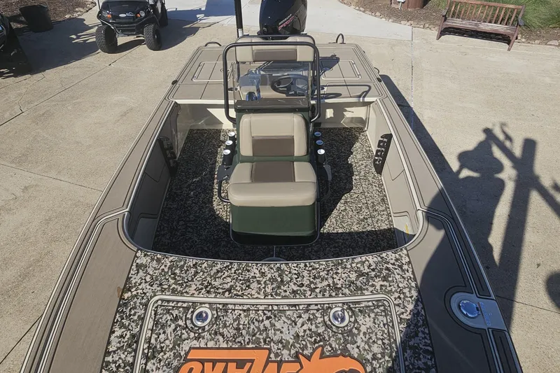 Slide: The Image of 2025 Mako 18 Pro Skiff Backwater Edition boat with camouflage interior and dual seating. - 9