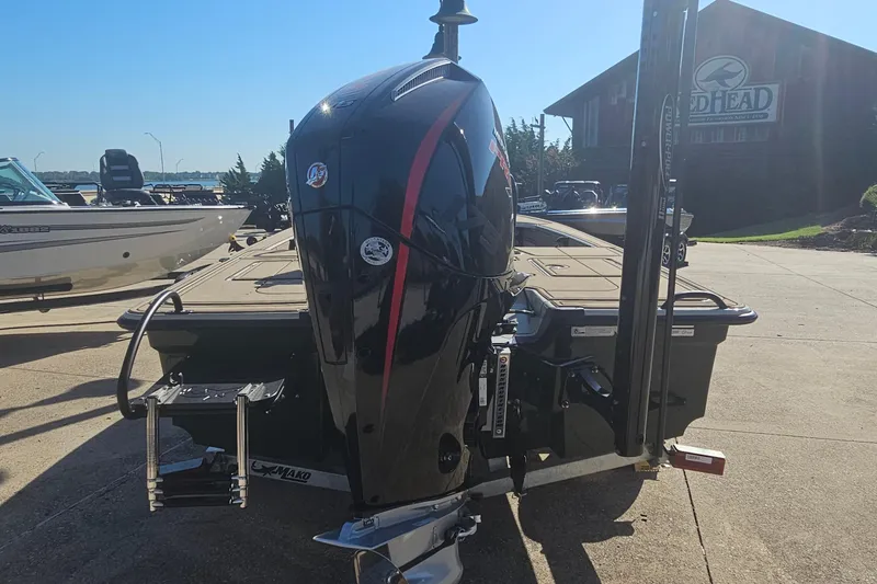 Slide: The Image of 2025 Mako 18 Pro Skiff Backwater Edition boat with powerful outboard motor in a sunny marina. - 3