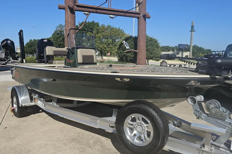 The Image of 2025 Mako 18 Pro Skiff Backwater Edition boat on trailer, outdoors, sunny day. - 0