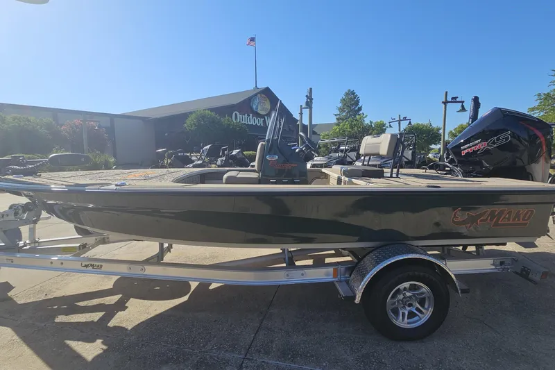Slide: The Image of 2025 Mako 18 Pro Skiff Backwater Edition boat on trailer, outdoor showroom display. - 5