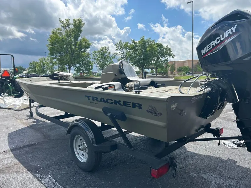 Slide: The Image of 2025 Tracker Grizzly 1754 SC boat on trailer with Mercury outboard motor, parked outdoors. - 3