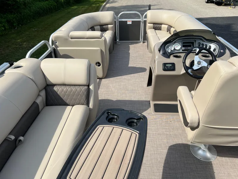 Slide: The Image of 2025 Sun Tracker Party Barge 20 DLX interior with plush seating and modern helm. - 3