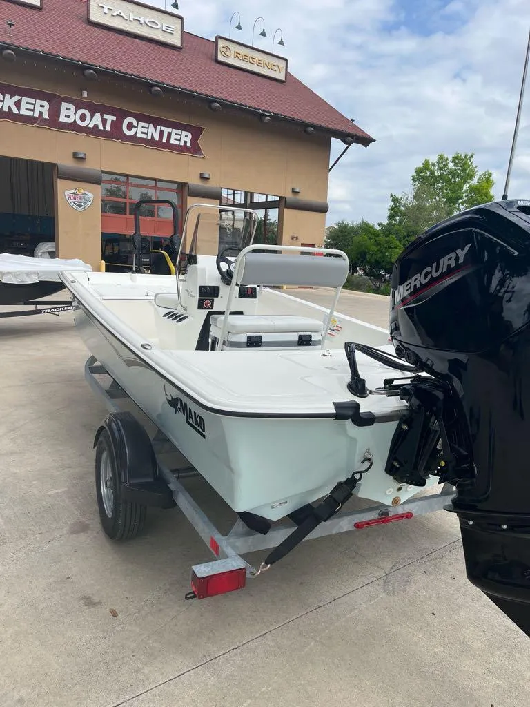 Slide: The Image of 2025 Mako Pro Skiff 17 CC boat on trailer at dealership. - 1