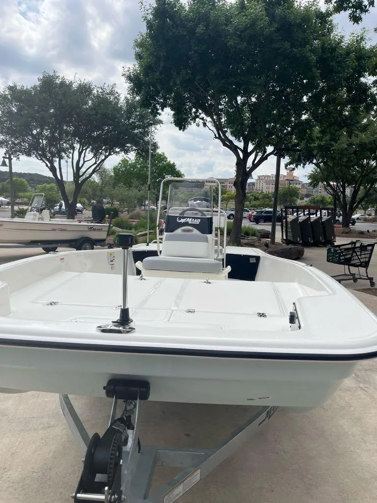 Slide: The Image of 2025 Mako Pro Skiff 17 CC boat on trailer, parked outdoors. - 6