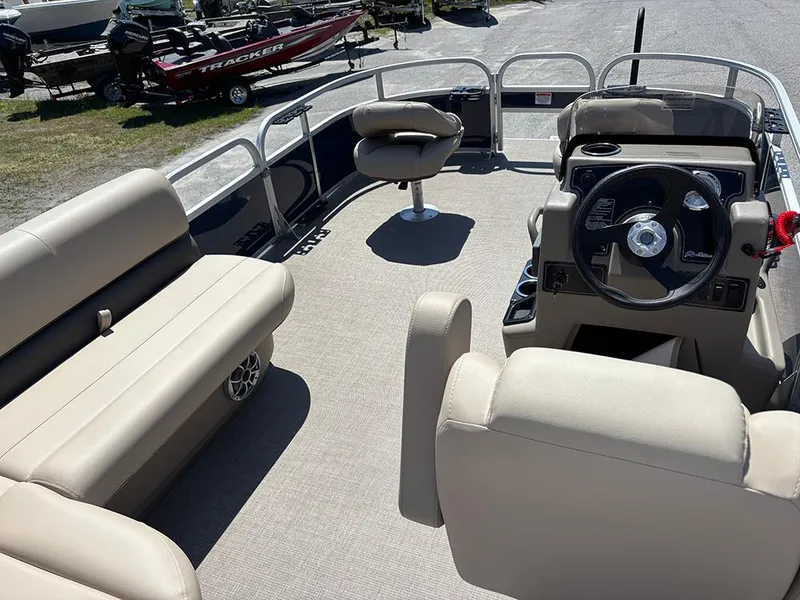 Slide: The Image of 2025 Sun Tracker Bass Buggy 16 XL Select pontoon boat interior with seating and steering console. - 10