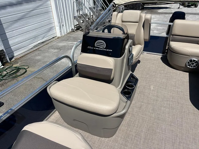 Slide: The Image of 2025 Sun Tracker Bass Buggy 16 XL Select pontoon boat interior with beige seating. - 12
