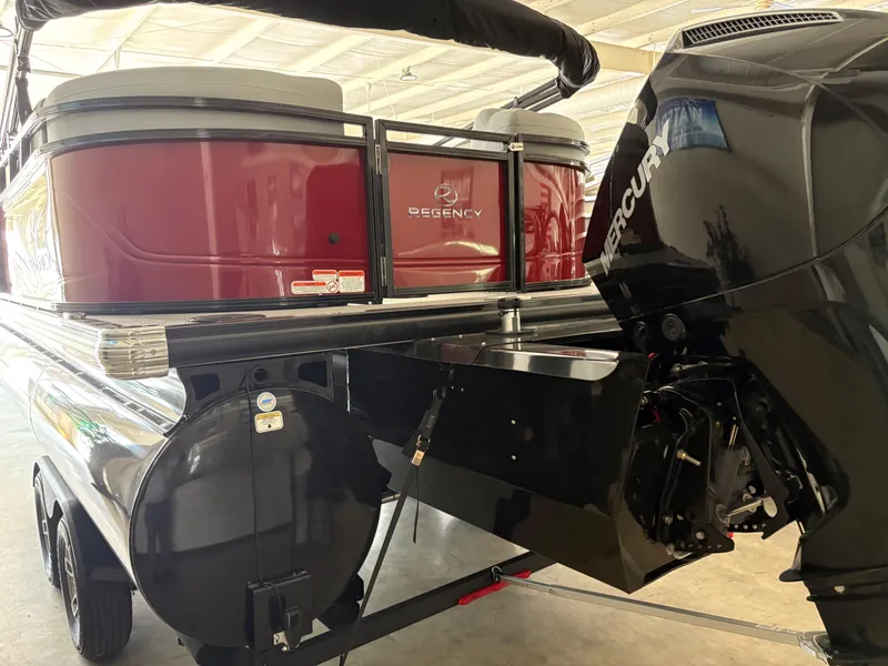 Slide: The Image of 2025 Regency 230 DL3 pontoon boat with Mercury engine in a showroom. - 4