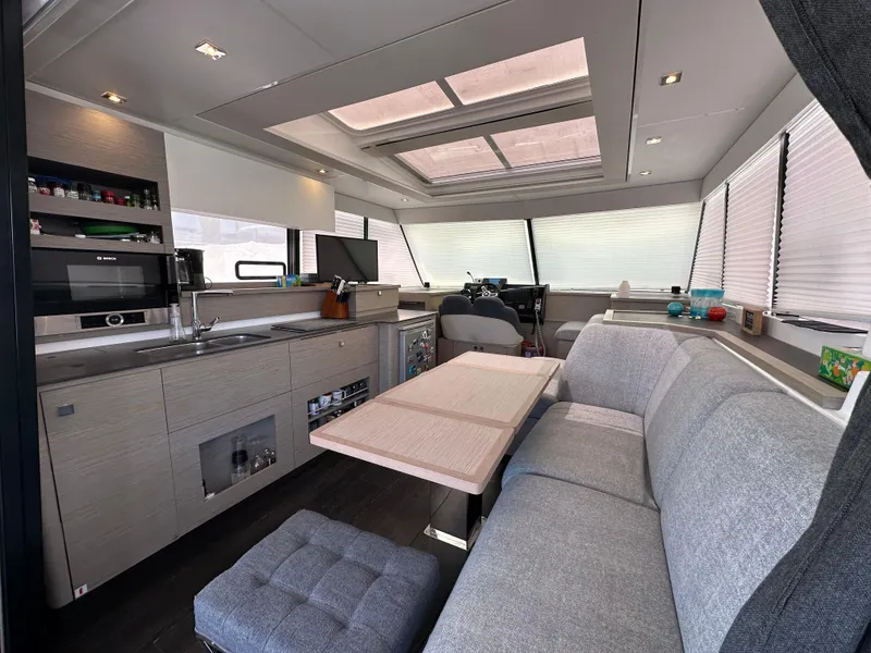 Slide: The Image of Luxurious interior of 2021 Fountaine Pajot MY4.S yacht with modern seating and table. - 11