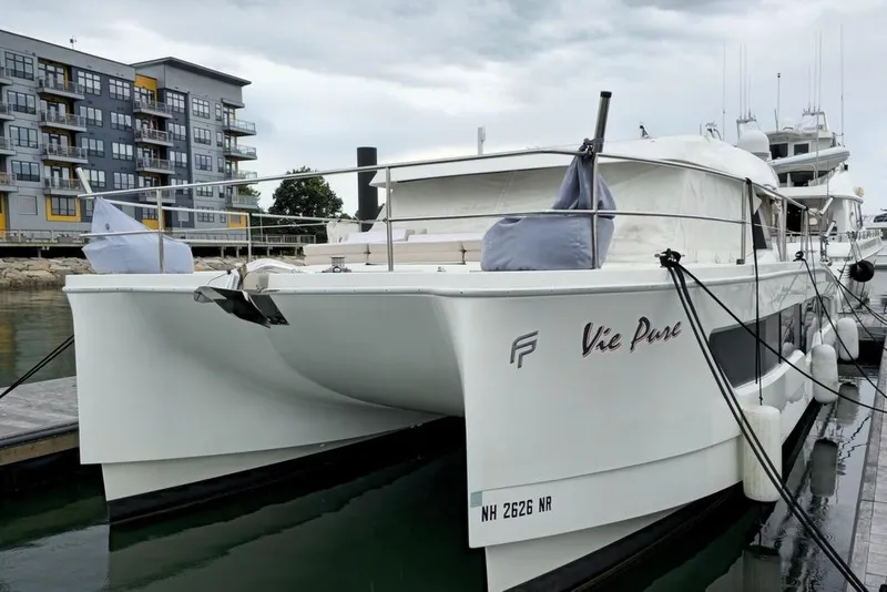 Slide: The Image of 2021 Fountaine Pajot MY4.S catamaran docked near modern waterfront apartments. - 60