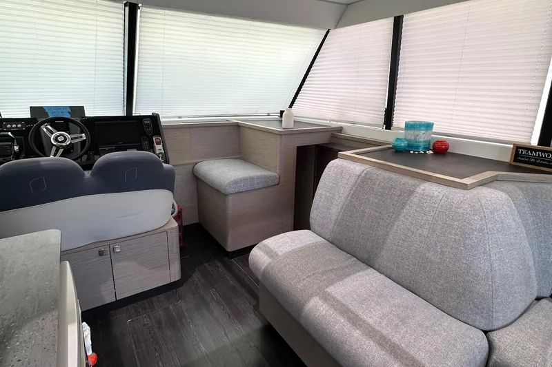 Slide: The Image of 2021 Fountaine Pajot MY4.S yacht helm with modern controls and comfortable seating. - 8