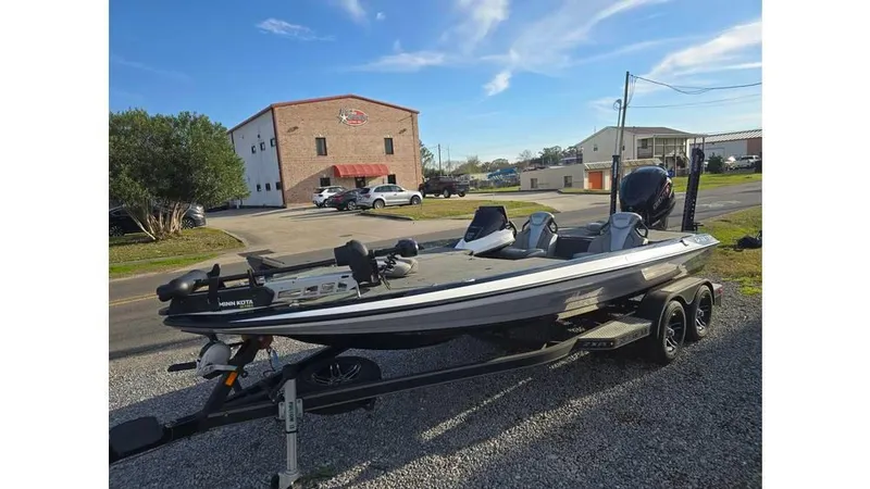 Slide: The Image of 2022 Skeeter ZXR20 boat on trailer, parked outdoors near buildings. - 4