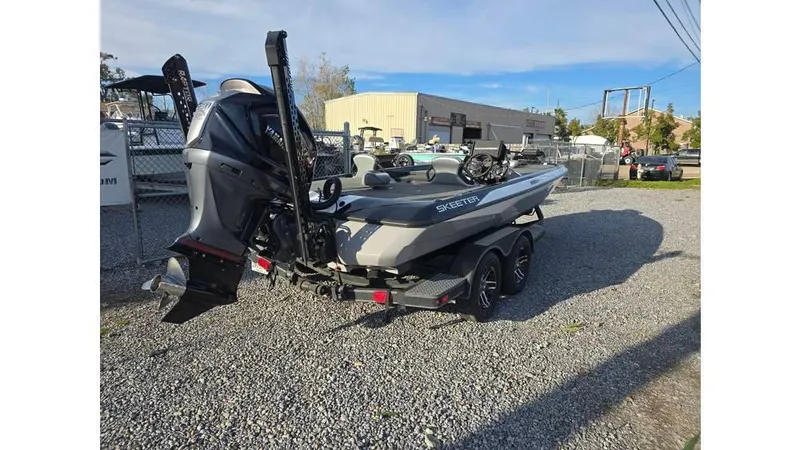 Slide: The Image of 2022 Skeeter ZXR20 boat on trailer, parked on gravel lot, rear view. - 7