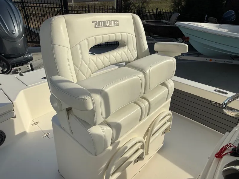 Slide: The Image of 2022 Pathfinder 2500 Hybrid boat seat with white cushioned design and armrests. - 11