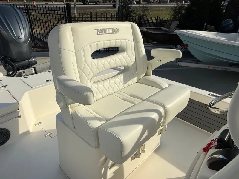 Slide: The Image of 2022 Pathfinder 2500 Hybrid boat seat with white cushioned design and armrests. - 12
