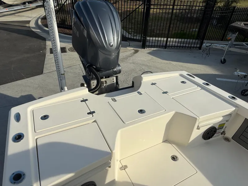 Slide: The Image of 2022 Pathfinder 2500 Hybrid boat with outboard motor and storage compartments. - 13