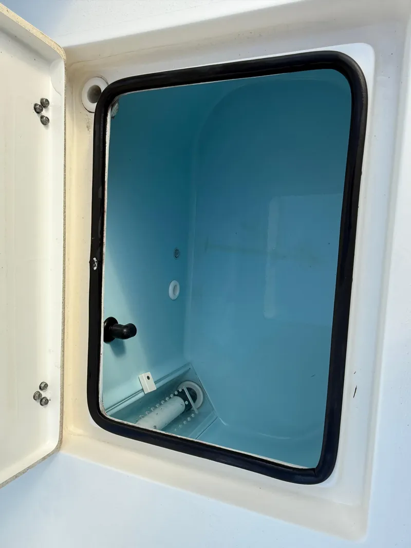 Slide: The Image of Pathfinder 2500 Hybrid 2022 boat storage compartment with open hatch. - 16