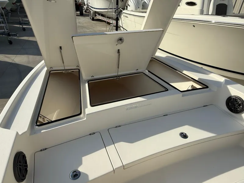 Slide: The Image of 2022 Pathfinder 2500 Hybrid boat storage compartments open, showcasing spacious interior design. - 6