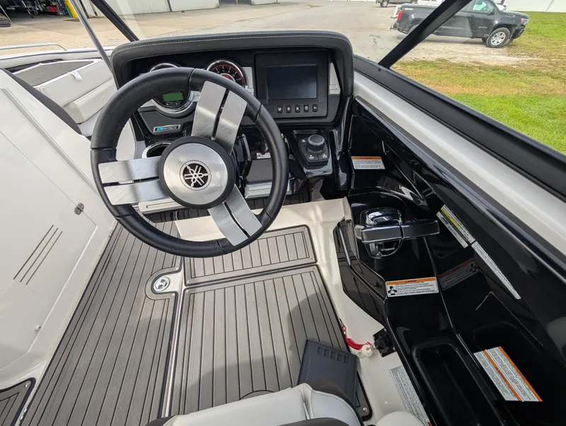 Slide: The Image of 2017 Yamaha Boats 242X E-Series cockpit with steering wheel and control panel. - 16
