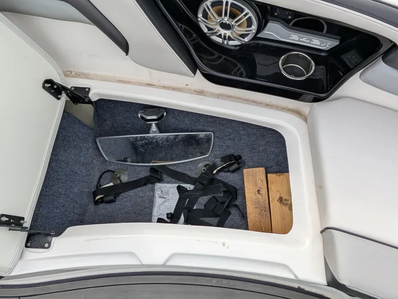 Slide: The Image of 2017 Yamaha Boats 242X E-Series storage compartment with accessories and speaker detail. - 20