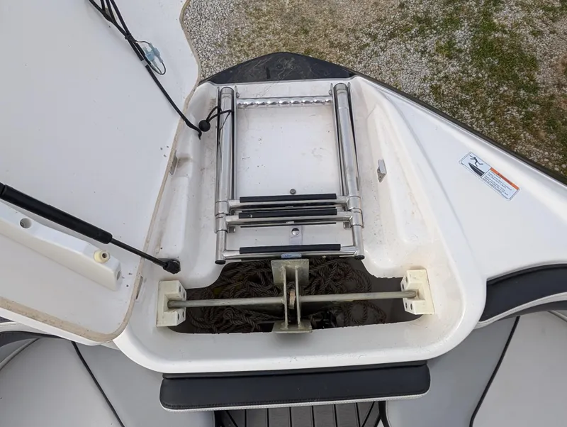 Slide: The Image of 2017 Yamaha Boats 242X E-Series bow storage with ladder and anchor compartment. - 22
