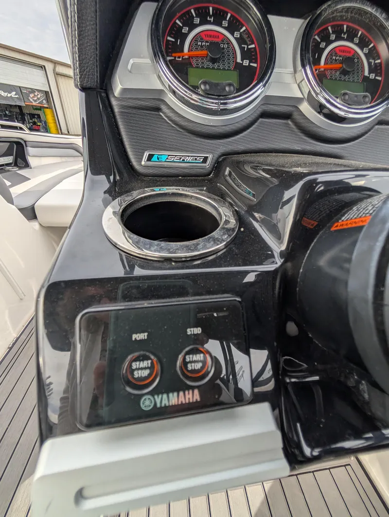 Slide: The Image of 2017 Yamaha Boats 242X E-Series dashboard with gauges and start/stop controls. - 28