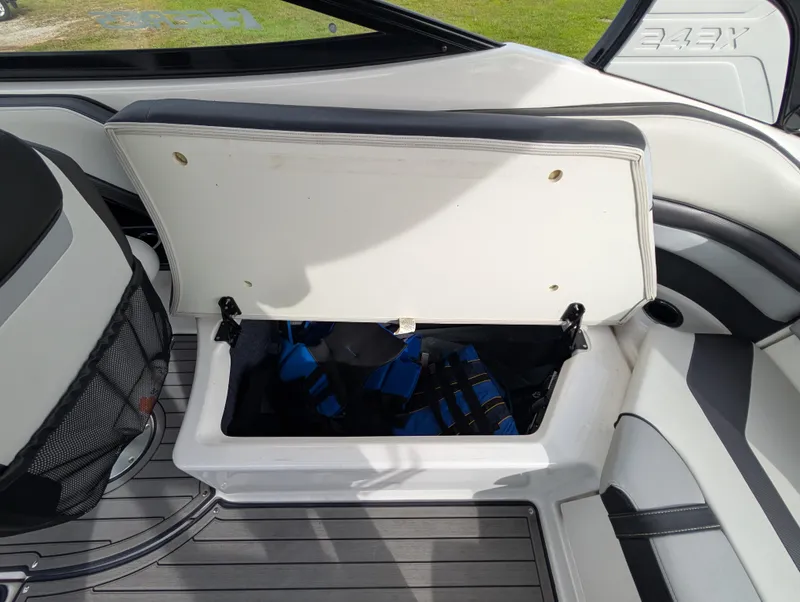 Slide: The Image of Open storage compartment on 2017 Yamaha Boats 242X E-Series, revealing interior space. - 34