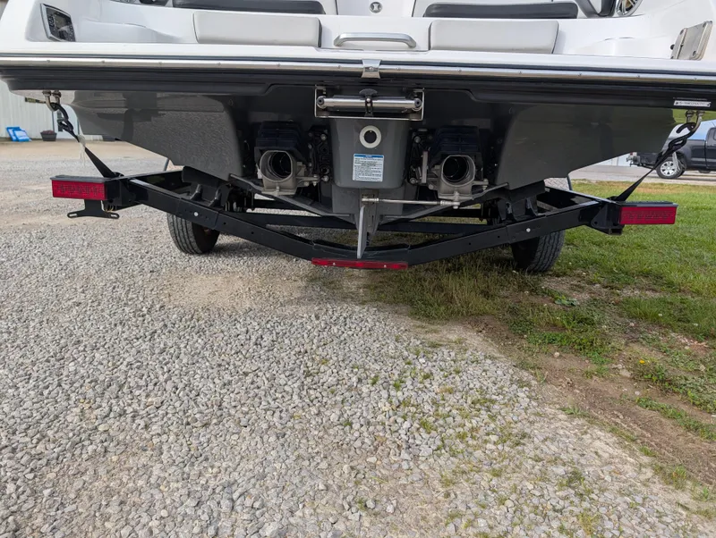 Slide: The Image of Rear view of 2017 Yamaha Boats 242X E-Series on a trailer, parked on gravel. - 9