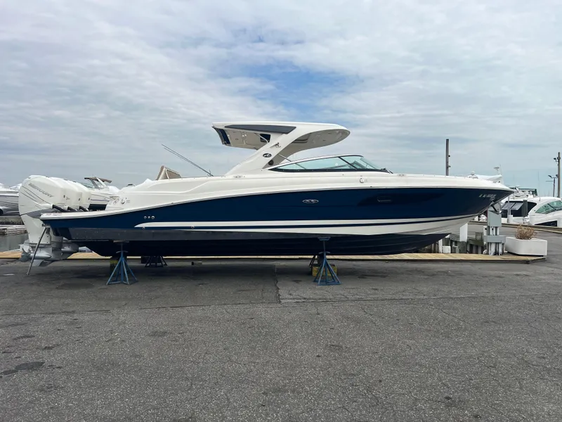 Slide: The Image of 2017 Sea Ray SLX 350 OB boat on display, blue and white exterior, docked on land. - 1
