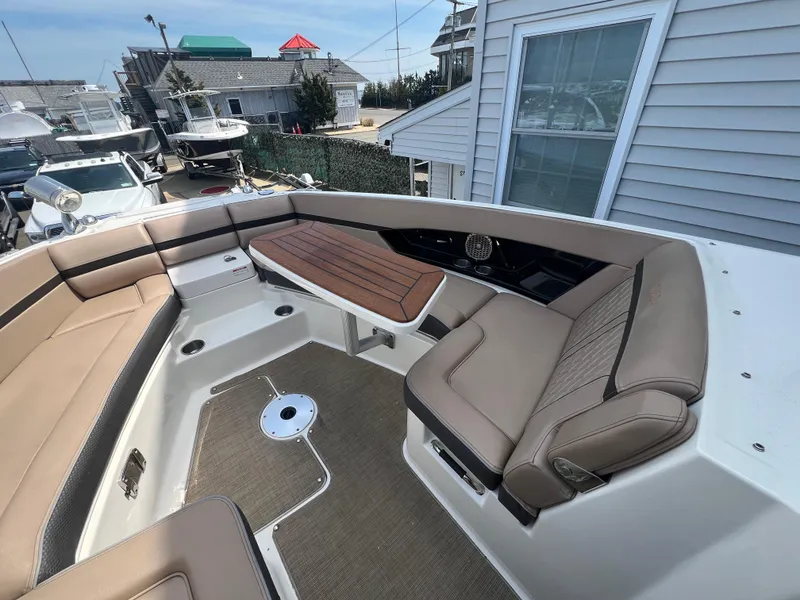 Slide: The Image of 2017 Sea Ray SLX 350 OB boat interior with tan seating and modern design. - 17