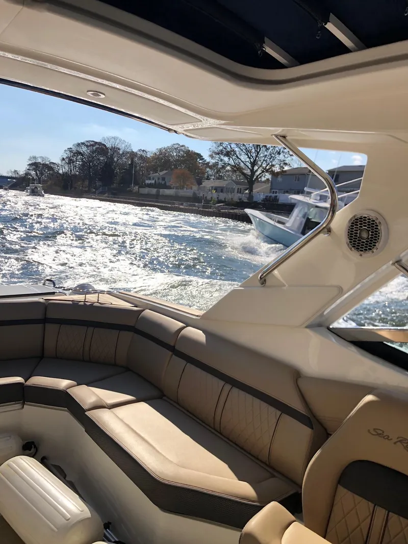 Slide: The Image of 2017 Sea Ray SLX 350 OB interior with scenic water view and luxurious seating. - 18